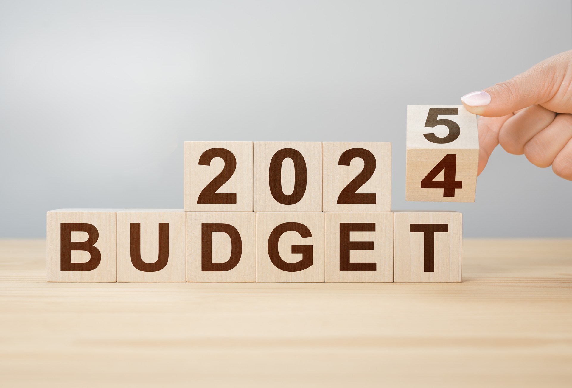 Business concept of planning 2025. Businessman flips wooden cube and changes words BUDGET 2024 to BUDGET 2025. New year business plan concept in 2025. Economy and business. 2025 BUDGET